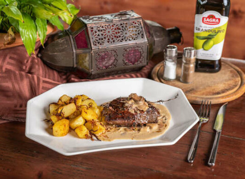 Steak z pravej hovädzej sviečkovice s opekanými zemiakmi a dubákovou omáčkou.