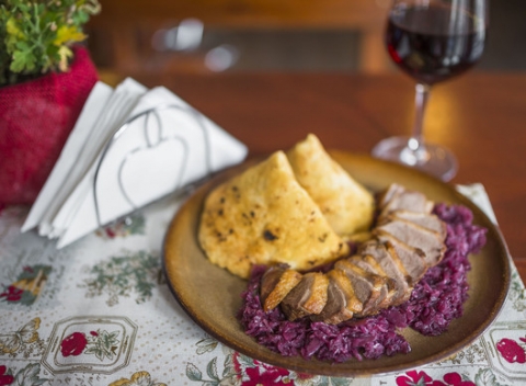 Chrumkavé pečené kačacie stehno alebo prsia s kapustou, lokšami a pohárom vína.